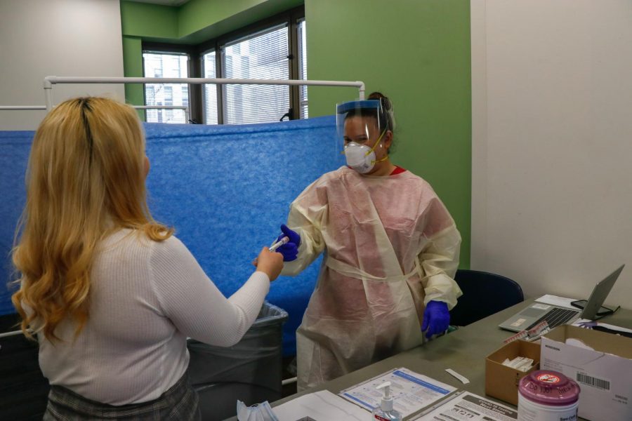 student getting an observed covid test at an on-campus testing center