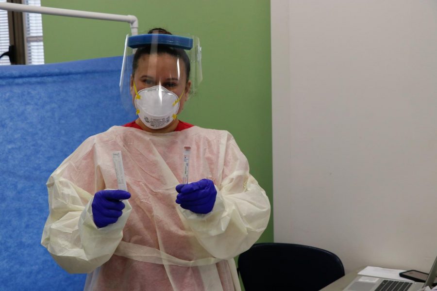 Melissa Quiroz in PPE holding Covid-19 test tubes