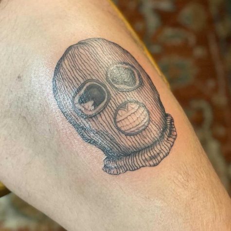 a tattoo of a skeleton wearing a ski mask