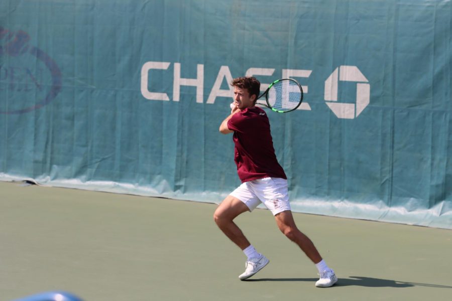 Fordham mens tennis player readies their racket at a match ahead of a possible championship.