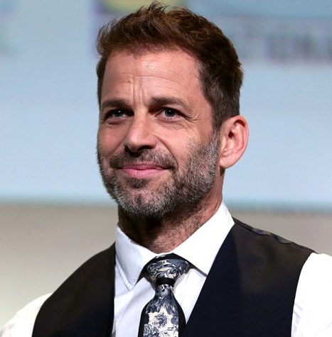 Justice League director Zack Snyder posing at a press event.