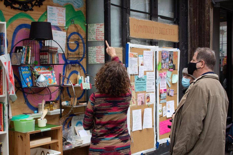 community organizer points at free store