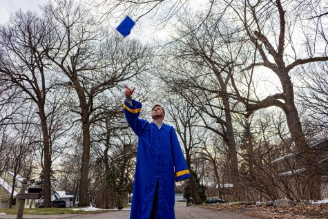 for an article about covid-19 photos, a graduating student tosses their cap in the air outside