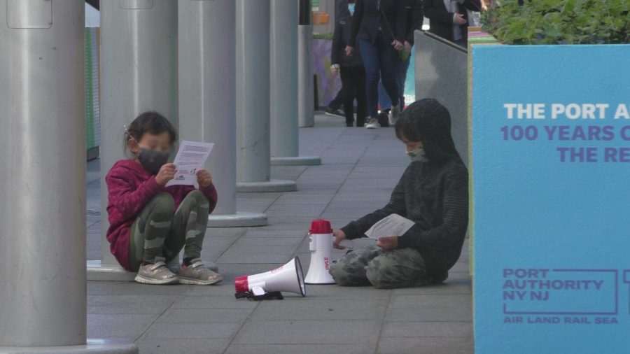 Two+children+reading+pamphlets+at+a+May+Day+rally.