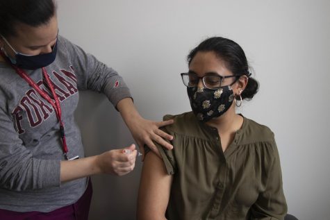 Photograph of a Fordham student receiving her COVID vaccine.
