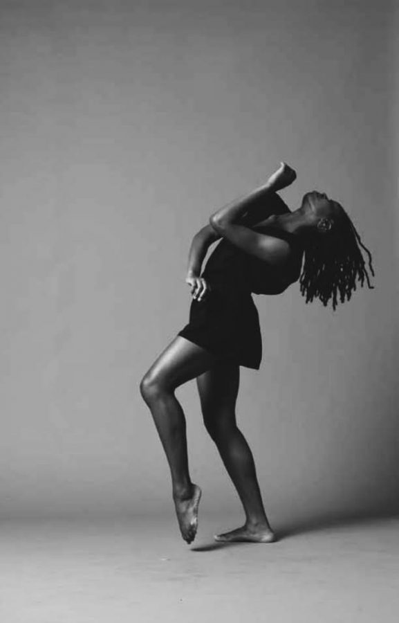 Minga Prather, a dancer, posing looking upward in a black and white photo