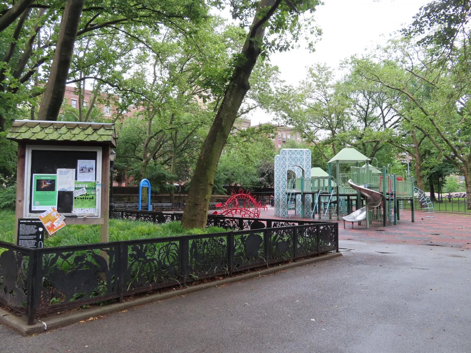 a playground in a park, featuring a Washington Bridge repplica