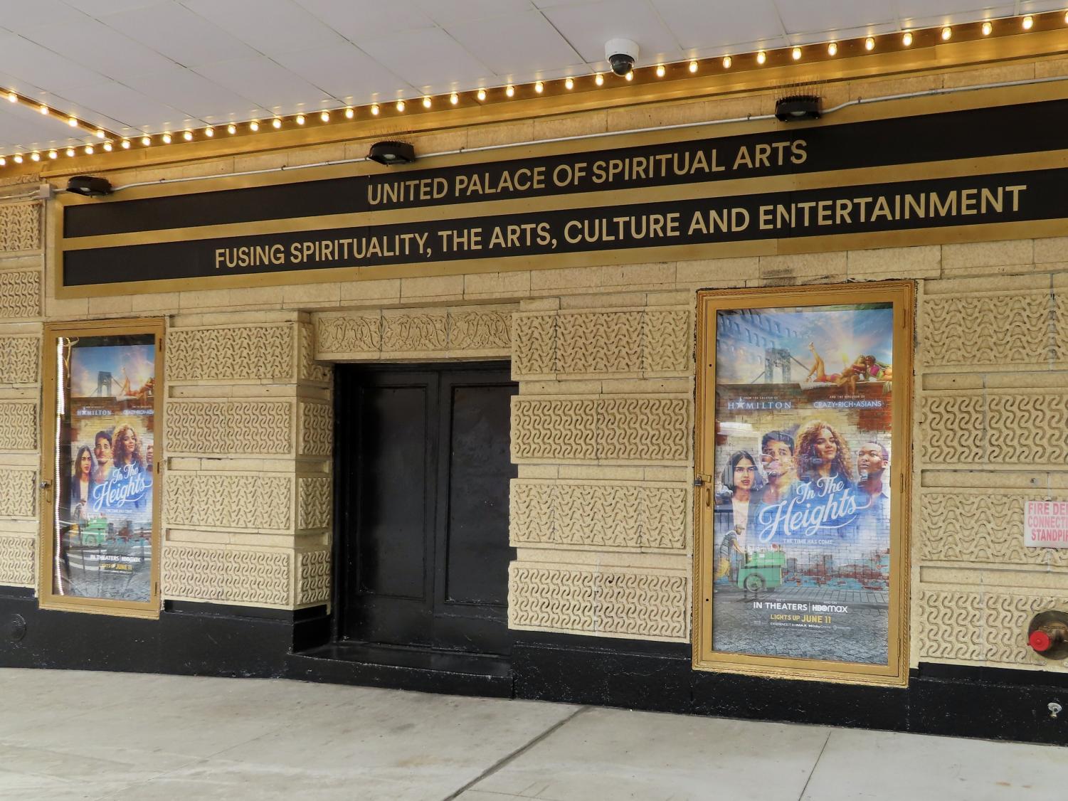 a movie theater with posters for "In The Heights" in the poster area