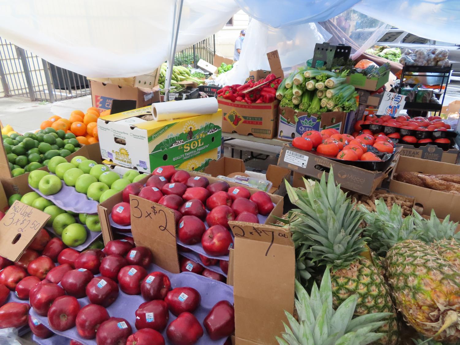 fresh fruit, including apples and pineapples, on display in a market