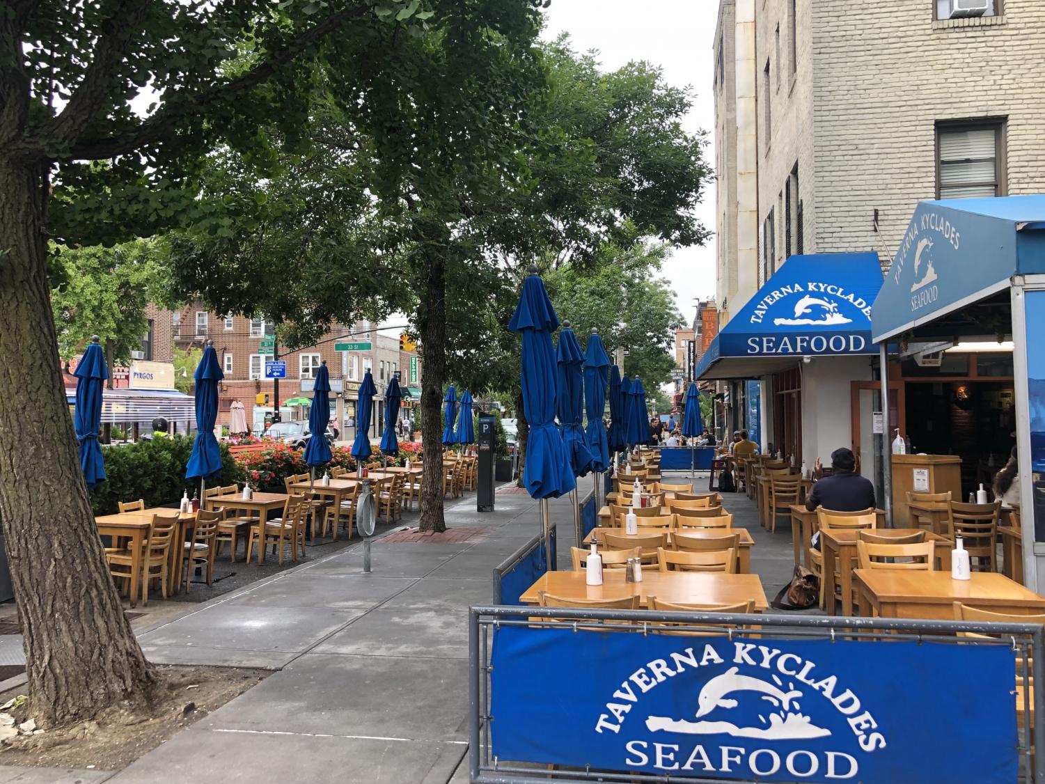 Taverna Kyclades Seafood and its blue signs on the street