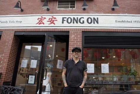 Fong On storefront with its new owner Paul Eng standing in front