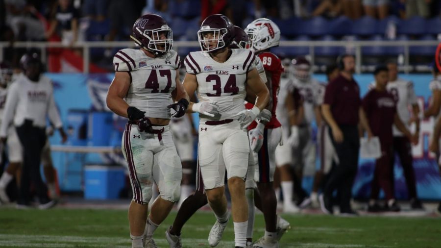 at the game against Florida Atlantic Owls, Ryan Greenhagen and Matt Jaworski talk on the field