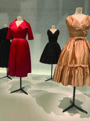 red, black and gold dresses on stands