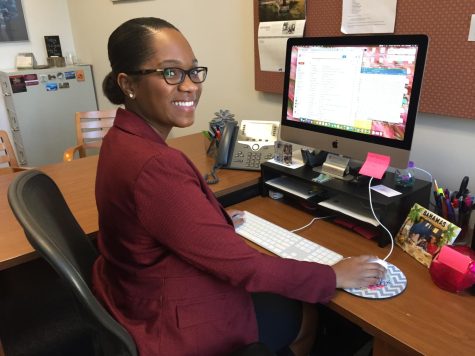 mica McKnight sits at her desk at Fordham Lincoln Center