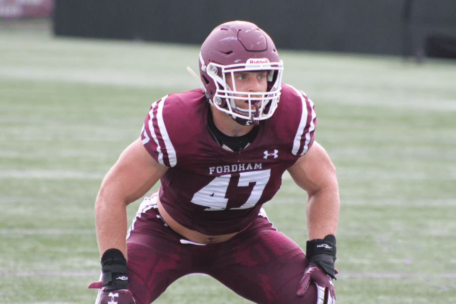 ryan greenhagen, number 47, crouches in preparation during a game