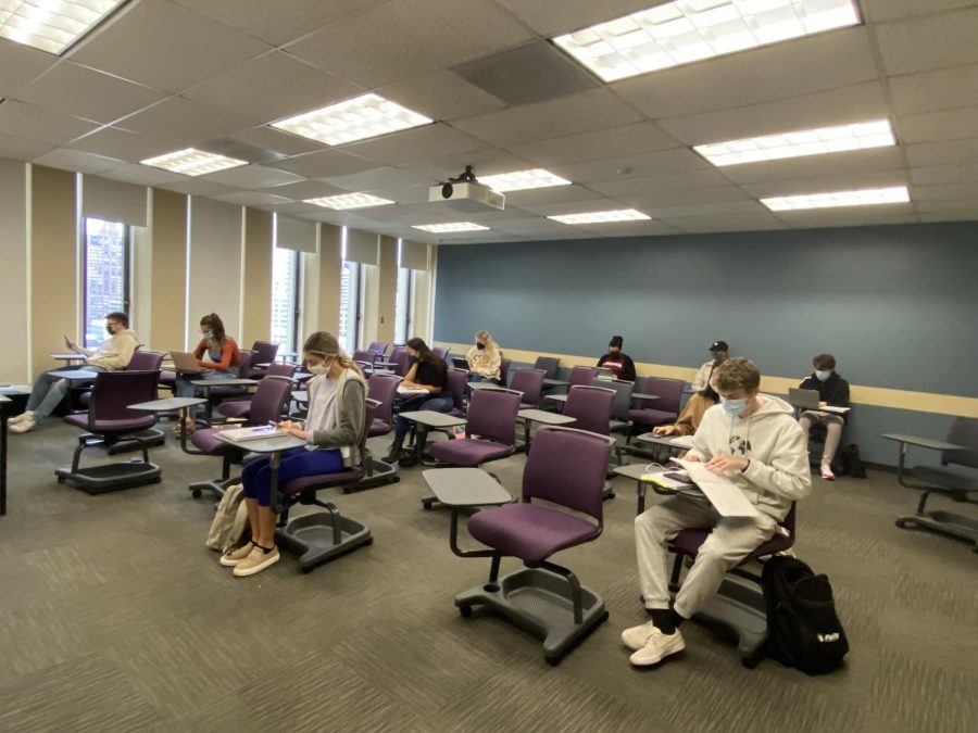 students sitting in a Fordham classroom wearing masks