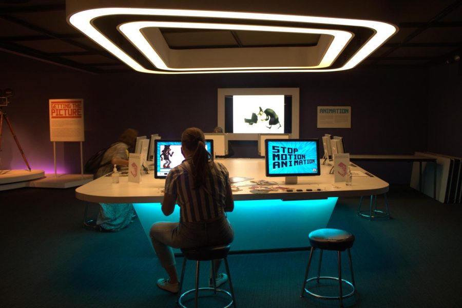 people sitting at a desk with blue light surrounding them