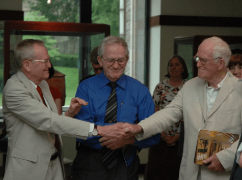 a photo of the McCabe brothers shaking hands, John, Francis, and James