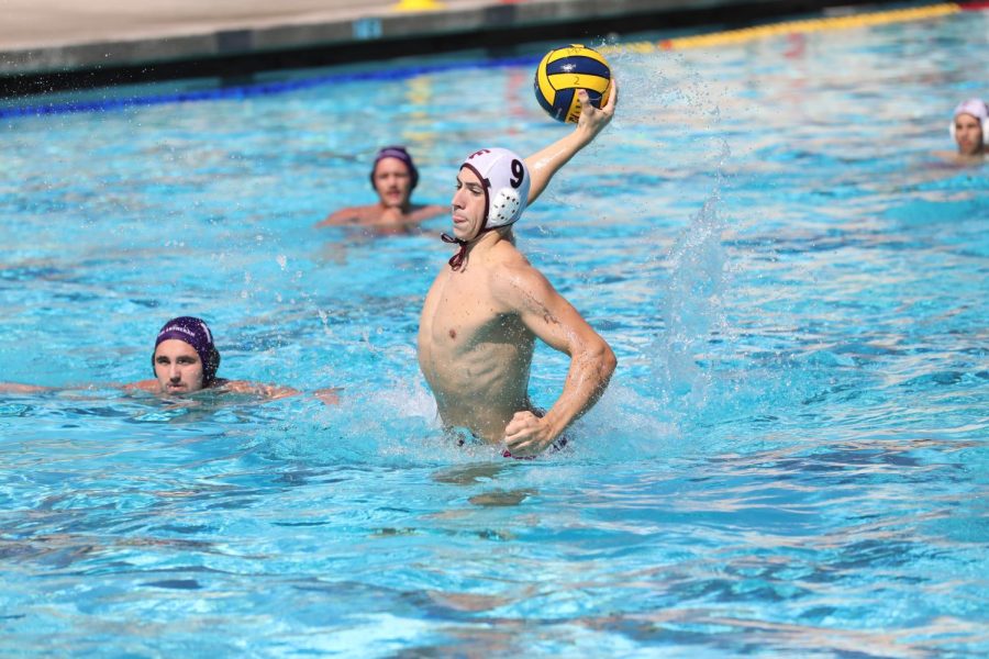 a water polo player spiking a ball