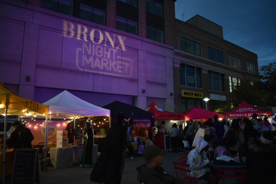 purple light with bronx night market spelt on a building