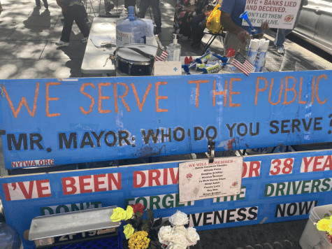 New York taxi worker poster saying "We serve the people, Mr. Mayor, who do you serve?"