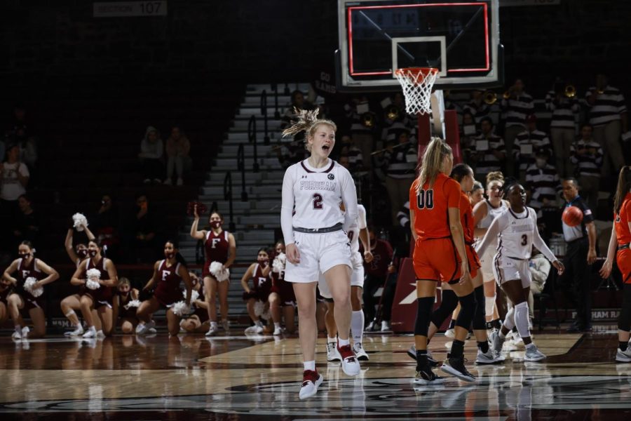 fordham basketball player with a princeton player in the background