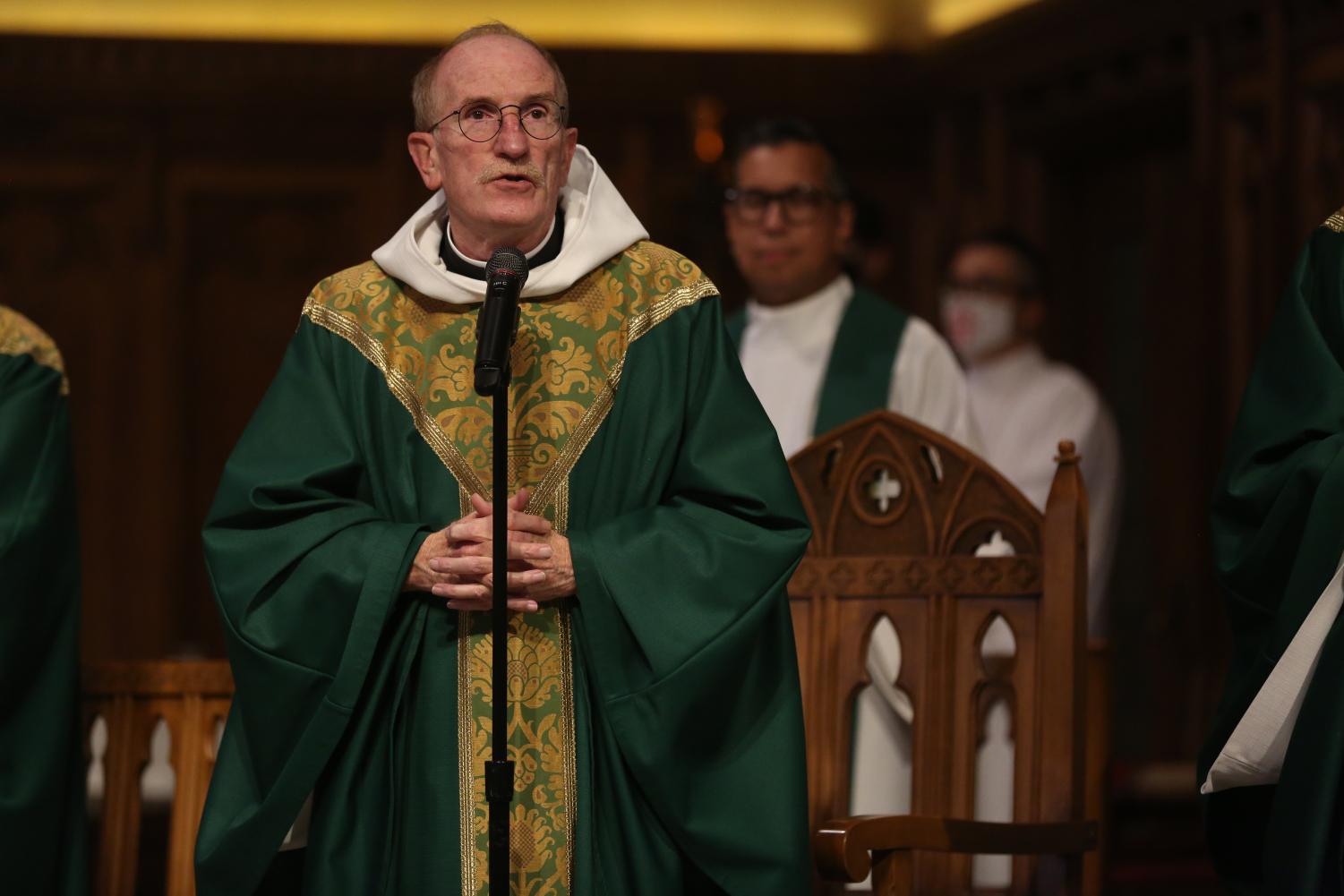 mcshane speaking at a mass in green vestments