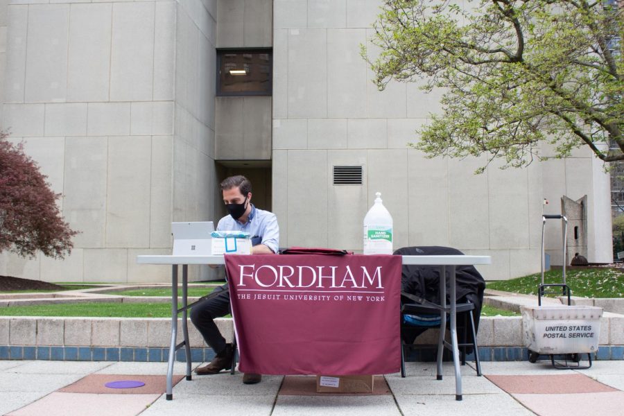fordham tours outside with table and man sitting at table