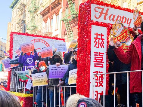 at lunar new year celebration people hold stop asian hate signs