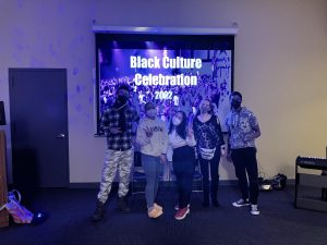 black culture celebration sign with students in front of it