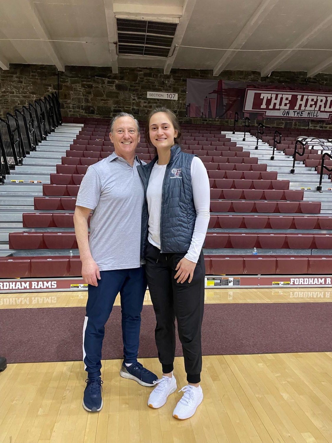 Brian kriftcher and edona thaqi stand in rose hill gym smiling