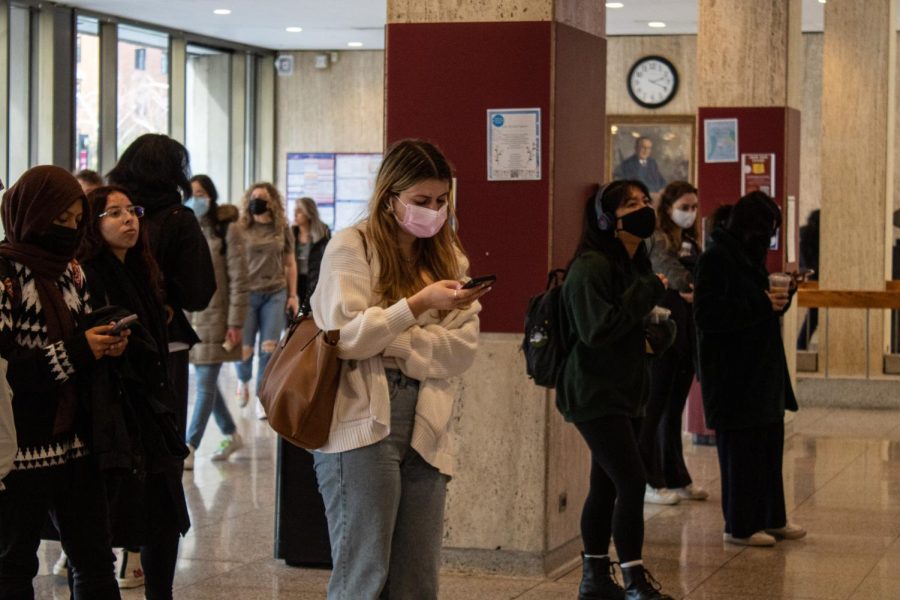students wearing masks outside elevators at fordham lincoln center