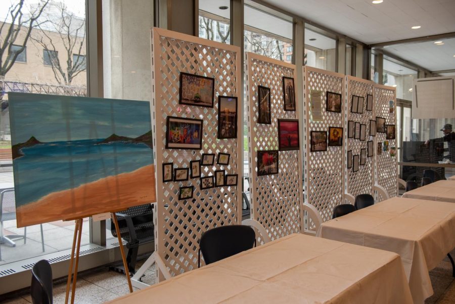 campus ministry art in the lowenstein plaza level lobby with paintings and photographs