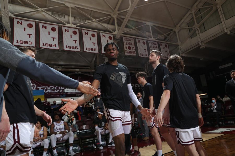 Ohams gets his name and number called before a game at the Rose Hill Gymnasium.