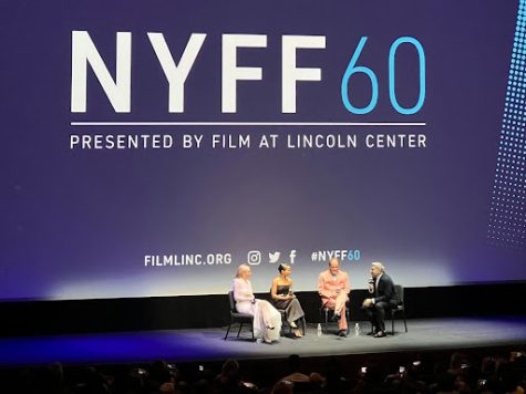 Four people sit on a spotlit stage with NYFF 60: Presented by Film at Lincoln Center on the screen behind them.