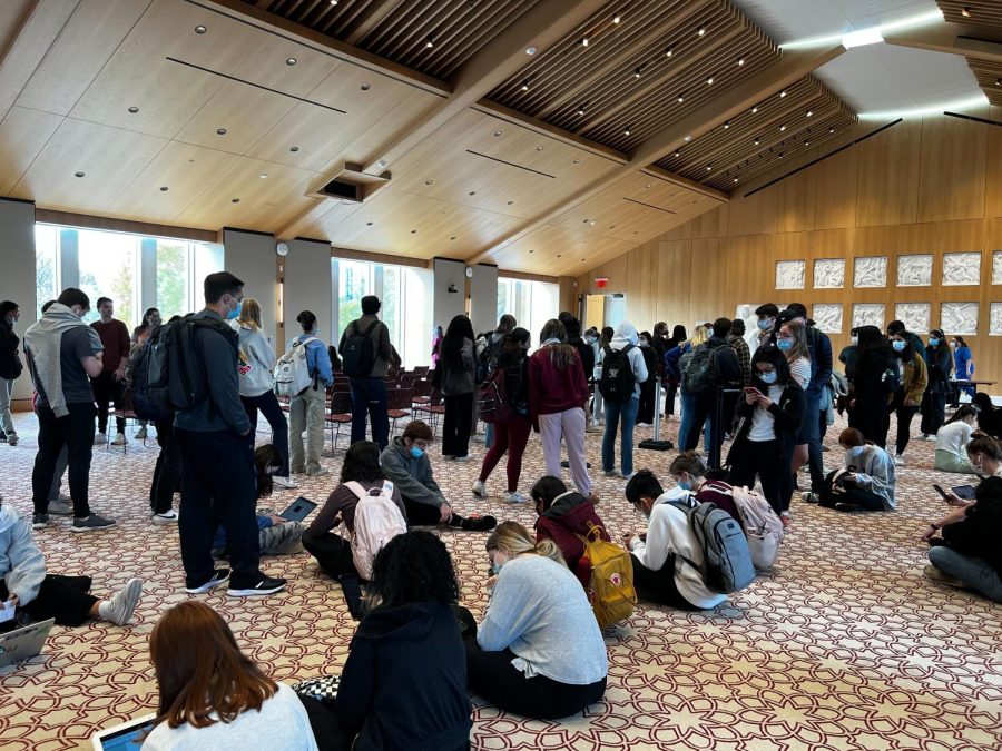 Students sit and wait upward of four hours inside the McShane Center’s Great Hall awaiting their bivalent booster dose on Oct. 31. 