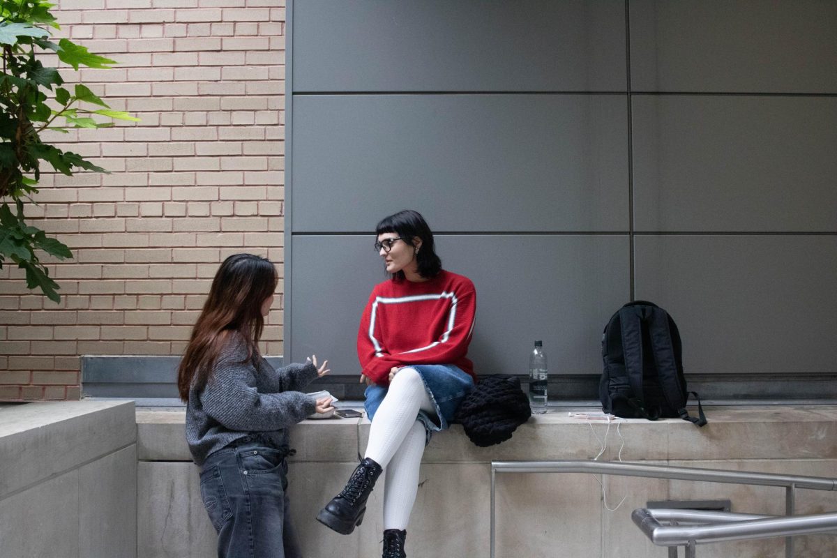 Free of technology, students chat in the Outdoor Plaza outside of the Gabelli School of Business. 