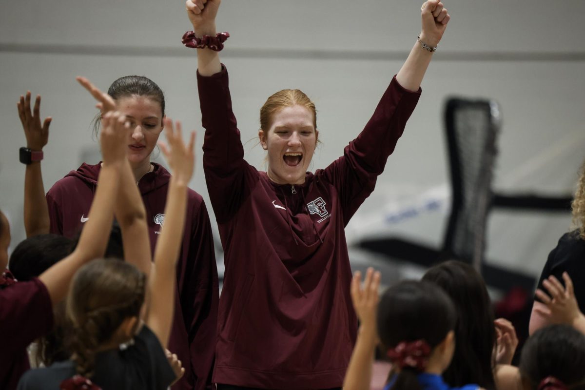 Fordham volleyball athletes at the sports clinic celebrating National Girls and Women in Sports Day.