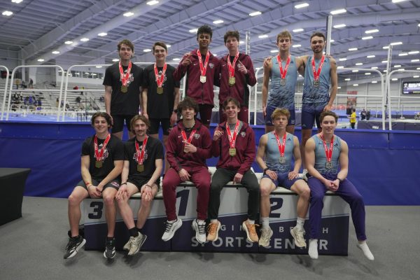 The men’s distance medley, made up of Rodolfo Sanchez, Sean Reidy, Nathaniel Bezuneh and Dakota Strain on the podium after receiving their gold medals.