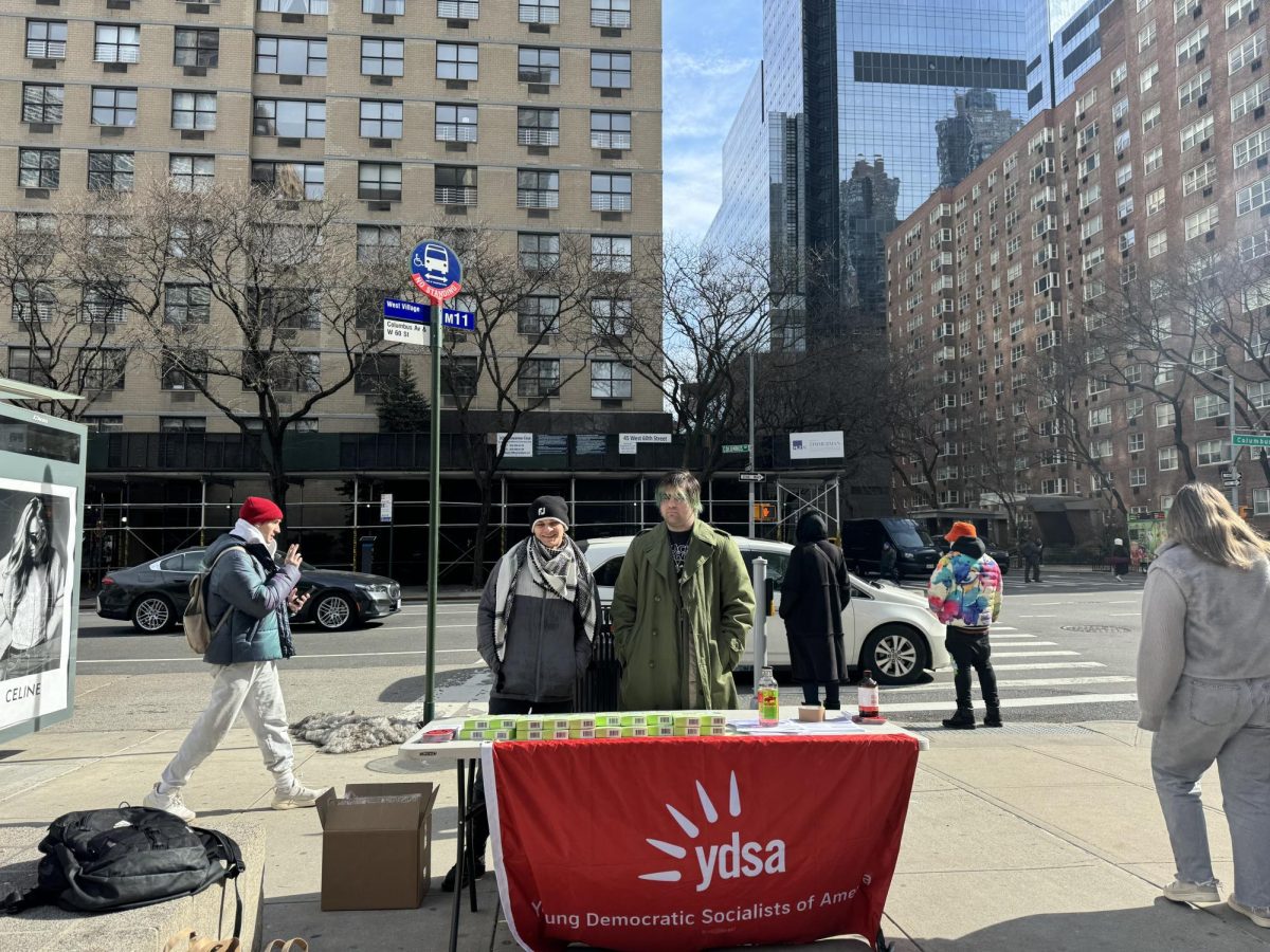 Two members of the YDSA standing outside of Lincoln Center handing out contraceptives. 