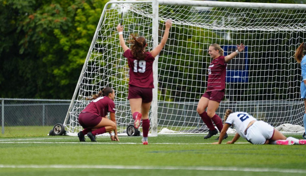 Julia Acosta celebrated with teammates after her goal that tied the game.