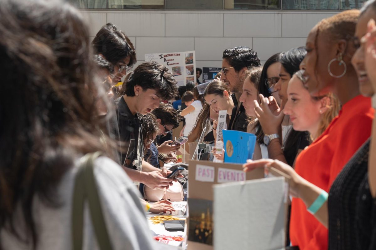 Fordham students speak with club leaders at the Club Fair.