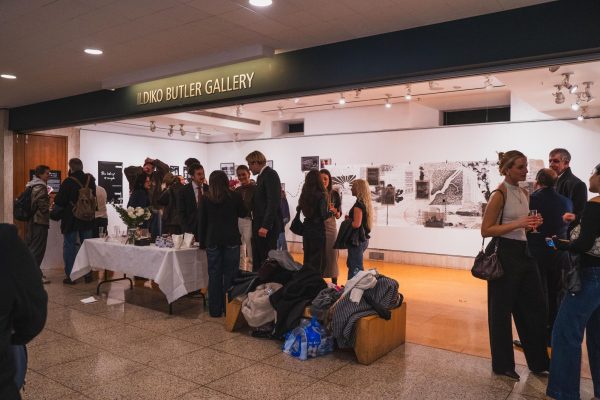 Fordham students, professors and friends and family of the artists observe the works on display.