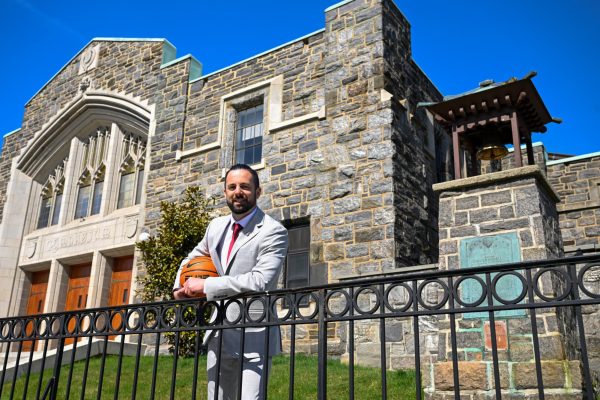 Neil Harrow stands outside the historic Rose Hill Gymnasium as his tenure with the Rams begins. 