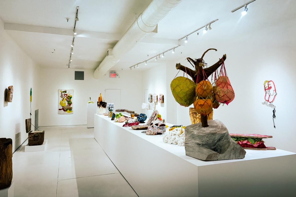 “Fancy Feast” by Brent Owens features a 24-foot-long display of fake food made entirely out of wood.
